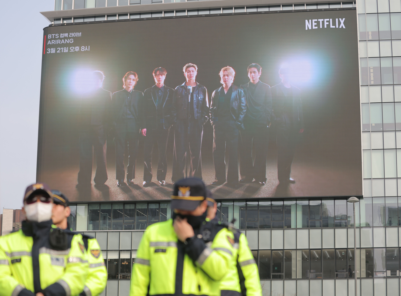 A promotional video for BTS’ upcoming concert at Gwanghwamun Square on March 21 plays on a large screen at the KT West building, located next to the performance venue in central Seoul, Wednesday. (Yonhap)